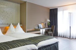 Katil atau katil-katil dalam bilik di Hotel Olten Swiss Quality