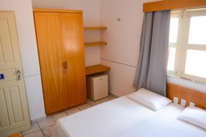 a small bedroom with two beds and a window at Hotel Villa Real in Sobral