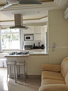 a kitchen with a couch and a table in a room at ILHAS CANARIAS APTO 101 in Florianópolis