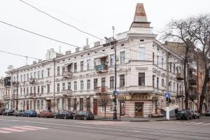 a large white building on the side of a street at Hotel Baron in Odesa