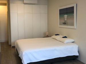 a bedroom with a white bed and a window at Bondi Beach Studio King Suite 1 in Sydney