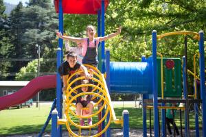 two girls playing on a slide at a playground at Warburton Holiday Park in Warburton +31 photos