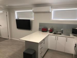 a kitchen with a refrigerator, microwave, sink and dishwasher at The William Apartments Jesmond in Newcastle