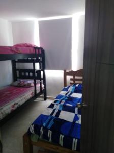 En eller flere senge i et værelse på Apartamento vacacional en Santa Marta