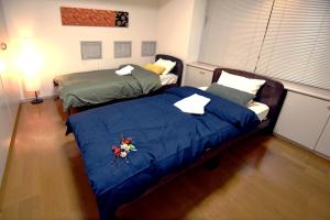 Llit o llits en una habitació de Guest room Kamakura Nagomi -Camellia-