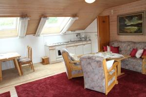 a kitchen and living room with a table and a couch at Appartementhaus Moos in Lam