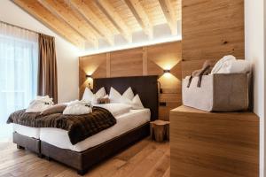 ヴァルト・アム・アールベルクにあるWestwood-Apartment mit Indoorpool und Saunaの木製の壁のベッドルーム1室(大型ベッド1台付)