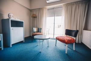 a room with a table and a chair and a window at Los Tilos Hotel y Spa by CPH in Villa Carlos Paz