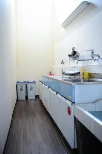 a kitchen with a sink and a counter top at Nishioji KADO 西大路 角 わんちゃんと泊まれるお宿 in Kyoto