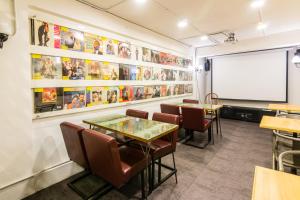 a meeting room with tables and chairs and a whiteboard at 321 Apartment B&B in Hualien City