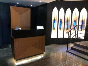 a lobby with surfboards on the wall and a counter at Imani Suites in Seminyak