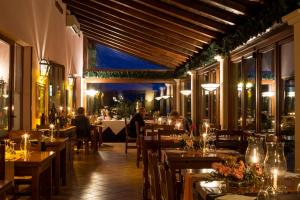 a restaurant with tables and people sitting at tables at Country Hotel & Resort I Calanchi in Ripatransone