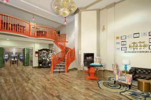 a lobby with a spiral staircase and a living room at Hotel Ylem in Houston
