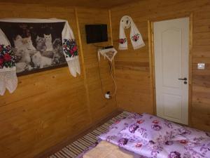 a bedroom with a bed in a wooden room at Floare de Maramures 2 in Sighetu Marmaţiei