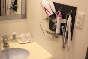 a bathroom with a sink and a toothbrush holder at Pal Annex Munakata (Love Hotel) in Munakata +2 photos