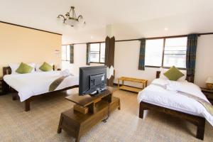 Postel nebo postele na pokoji v ubytování Somwang Boutique Hotel + 37 fotografií