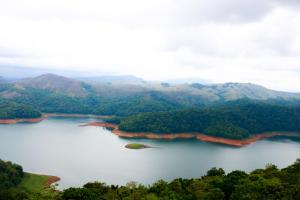 an aerial view of a lake with mountains at Mountain Breeze Villa and Homestay in Idukki