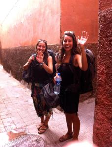 two women standing next to a wall with drinks at BED SQUARE Hostel in Marrakesh
