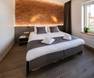 Een bed of bedden in een kamer bij Dangė Hotel