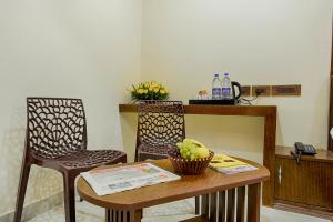 a room with a table and two chairs and a counter at Hotel Ramraj Regency in Nāgercoil