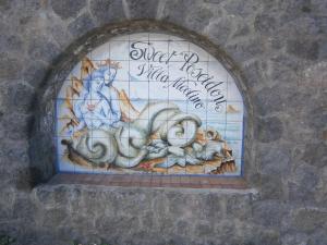a mural on the side of a building with an octopus at Sweetposeidon in Ischia