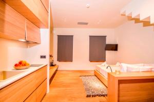 a room with a sink and a bed in a room at Portou House in Chania Town