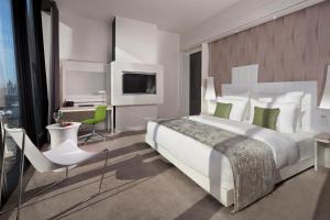a hotel room with a bed and a chair at Melia Vienna in Vienna
