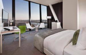 a hotel room with two beds and a television at Melia Vienna in Vienna