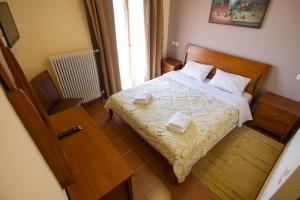 Ένα ή περισσότερα κρεβάτια σε δωμάτιο στο Vasilitsa rooms