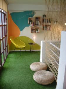 Zimmer mit grünem Teppich, Tisch und Stühlen in der Unterkunft Hotel Lo Monte in Pilar de la Horadada