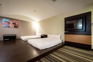 Postel nebo postele na pokoji v ubytování Yoyo Hotel