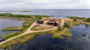 an aerial view of a house on an island in the water at Ūdens Tūrisma Attīstības Centrs Bāka in Gaigalava