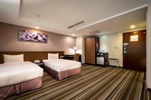 Postel nebo postele na pokoji v ubytování Yoyo Hotel