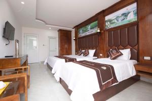 Säng eller sängar i ett rum på Vientiane Garden Villa Hotel