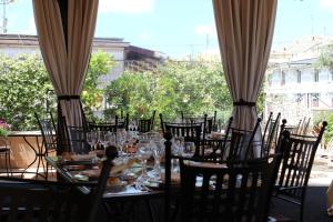 a table with chairs and wine glasses on a patio at Hotel dei Consoli Vaticano in Rome