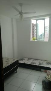 a white room with two beds and a window at Carlos Roberto Da Costa in Nossa Senhora do Livramento +21 photos