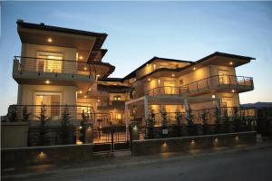 a large building with lights on the side of it at Rodolithos Beach in Stavros
