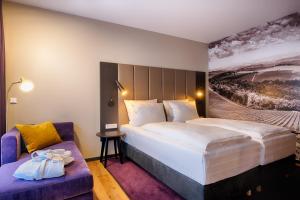 En eller flere senger på et rom på Welcome Hotel Neckarsulm