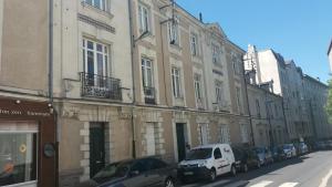 a street with cars parked in front of buildings at Azulejo by Cocoonr in Nantes