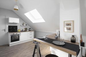 a kitchen with white cabinets and a counter top at Azulejo by Cocoonr in Nantes