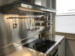 a stainless steel kitchen with a stove top oven at City Loft in Freudenstadt