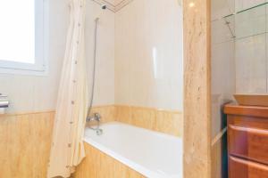 a bathroom with a bath tub and a shower at Lluna Home in Colonia Sant Jordi +32 photos