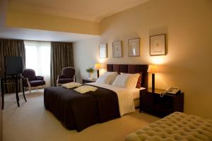 a hotel room with a bed and a television at Santana Hotel & SPA in Vila do Conde +93 photos