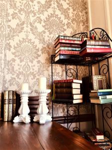 a room with a table with books and a shelf of books at Westcliff in Seascale