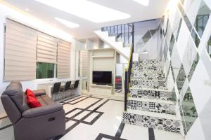 a living room with a staircase and a couch at RedDoorz near IPB Dramaga Bogor in Bogor