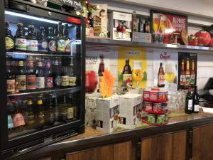 a bar with a lot of bottles of beer at La Hourquie Café in Morlaas