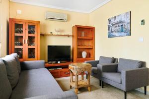 a living room with couches and a flat screen tv at Apartment Eden in Guardamar del Segura
