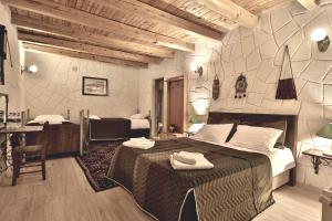 a hotel room with a large bed and a desk at Days inn Cappadocia in Goreme