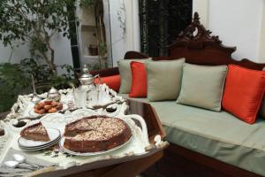 a table with a cake on top of a couch at El Patio Courtyard House in Tunis +40 photos