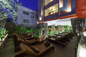 a restaurant with couches and tables in a building at Golden Temple Boutique in Siem Reap